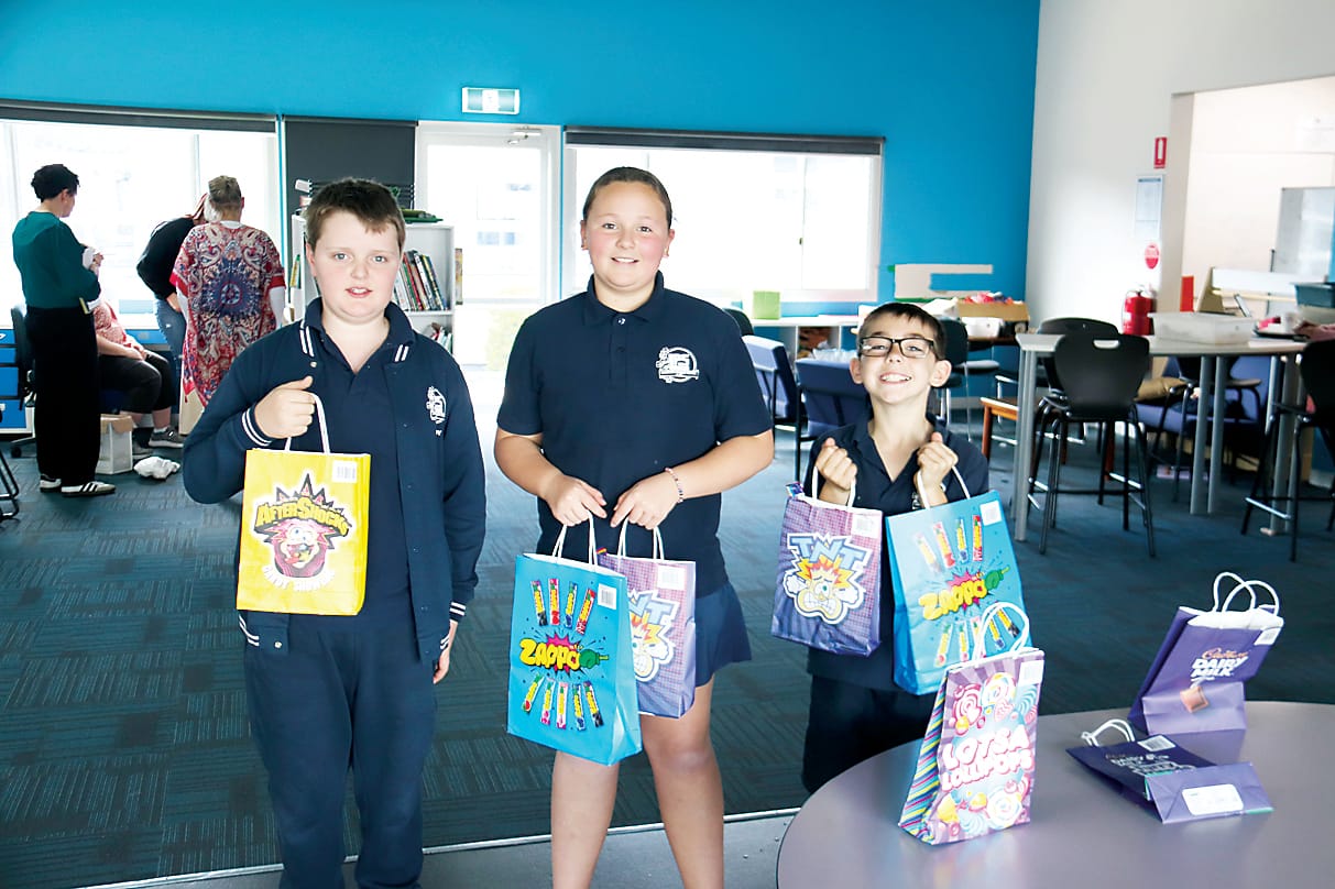 Quin Judd, Winta Hoeksema and Cooper Aslett displaying the showbags they have put together for the carnival.