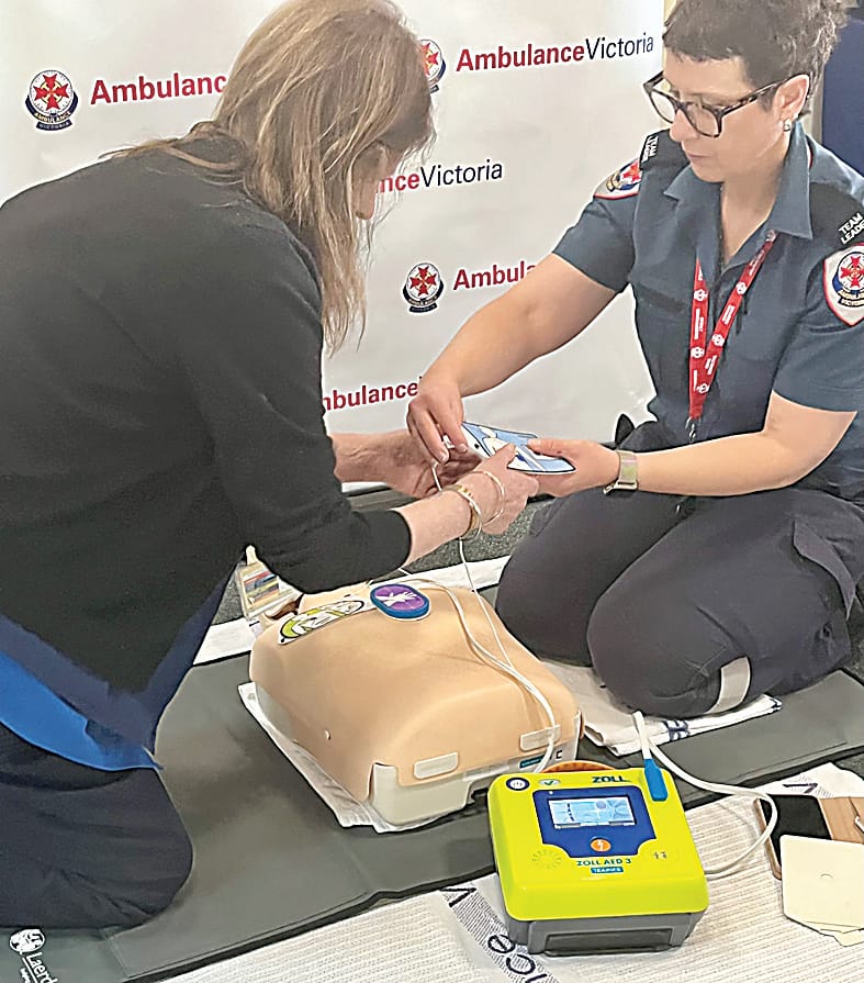 First responder Jennifer Hume guides West Gippsland Healthcare GROUP staff member Sue James through the use of a defibrillator (AED) to help someone that has suffered a heart attack until paramedics arrive.