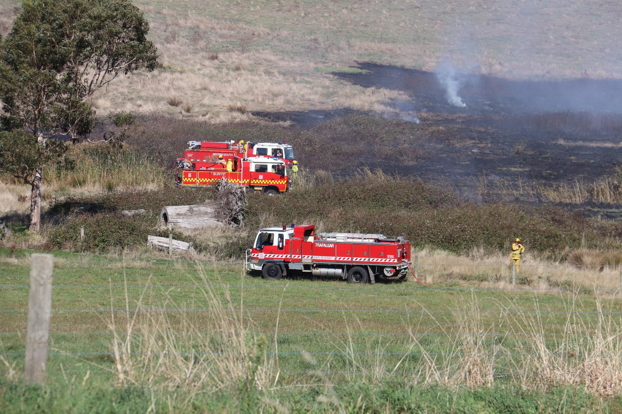 CFA volunteers work to extinguish a 20 acre grassfire in Drouin on Thursday afternoon. The fire was ignited after a suspicious fire at an abandoned farmhouse on Weebar Rd.