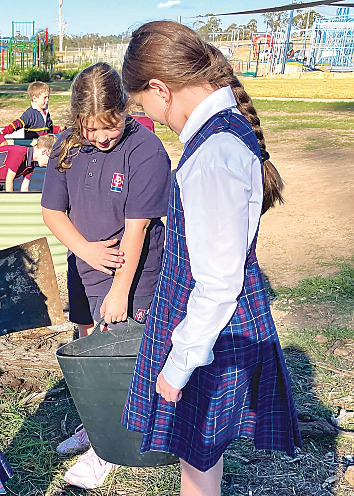 Blaire Davey and Heidi McCann work collaboratively in the garden.