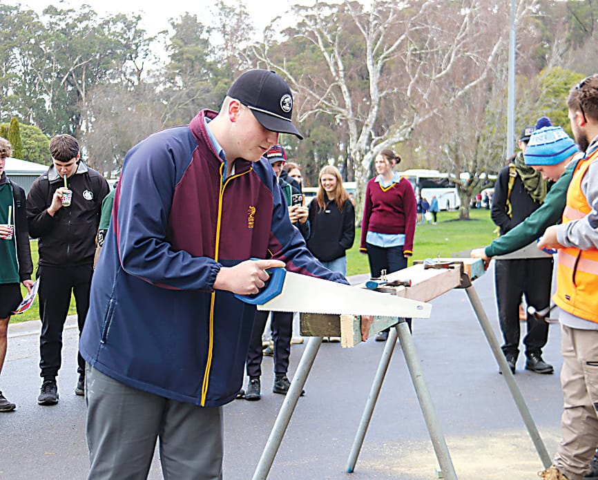 Left: On the Victoria Police stand are (from left) leading senior constable, Paula Fowler, Drouin Secondary College students Aaron Lawrence and Brodie Brindley and leading senior constable Warren Briggs.Right: At the Students of the World Exchange stand are Clare Sacker with Trafalagar High School  studnets Tilly Ott and Alexander Wheatland.