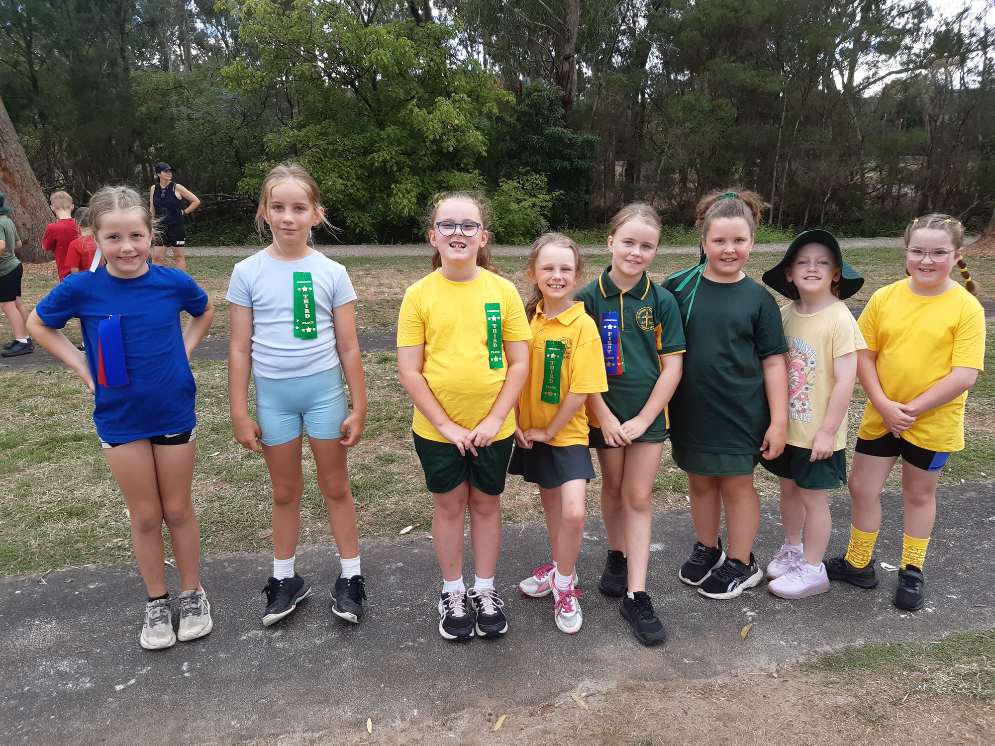 All smiles as they line up for an event at the Geoff Watt track are Sophie, Harriet, Izzy, Nicole, Adi, Maya, Macka and Nina.