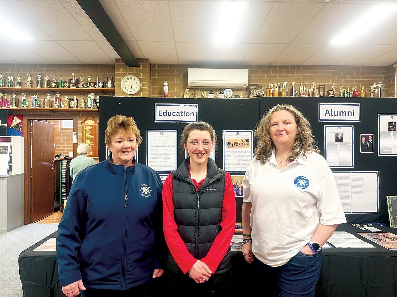 Exploring the Warragul Municipal Band exhibition at the Bruce Armstrong Band Room are Alice Weatherall, Julia Curl and Lindsay Snell.