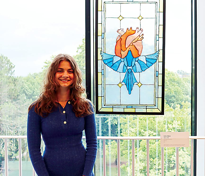 Esther Miljons from Lavalla Catholic College stands proudly with her stained glass artwork.