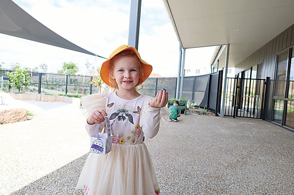 Prep student Navy May has fun finding eggs.