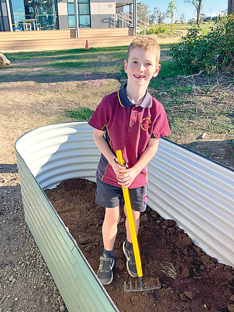 Reef McDonald develops his raking skills right inside a new garden bed.