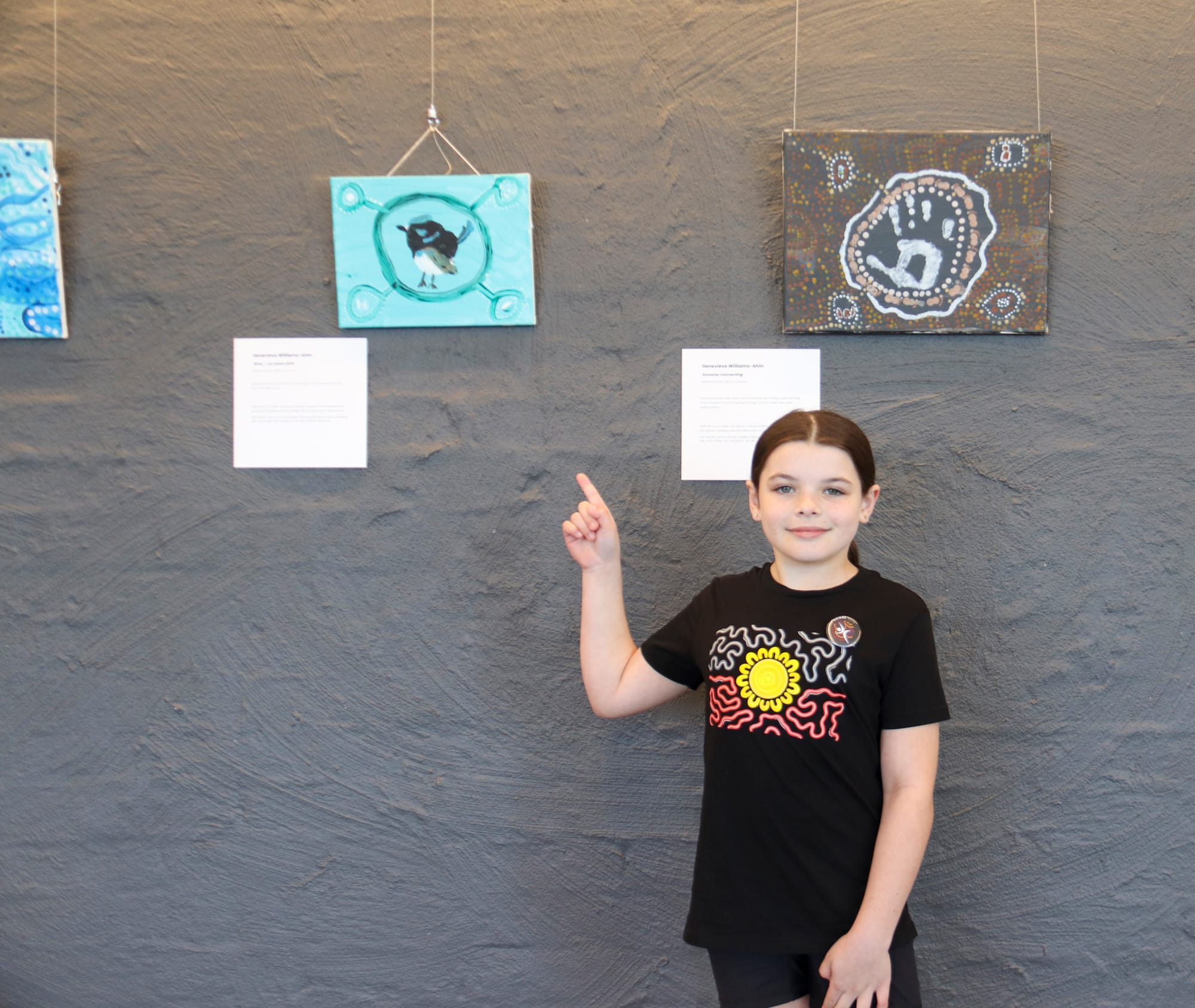 Ten-year-old Genevieve Williams stands proudly with some of her artwork on display at the West Gippsland Arts Centre.