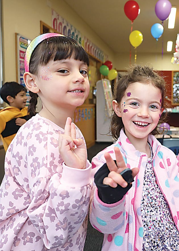 Harriet Grimshaw and Lucy Gunn pose in their very colourful outfits.