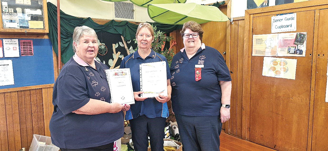 Linda Harvey (centre) with her two awards - good service and flowering gum - congratulated by Strzelecki Boomerang Trefoil Guild president Roxanne Purvis and state trefoil advisor Jill Livingston.
