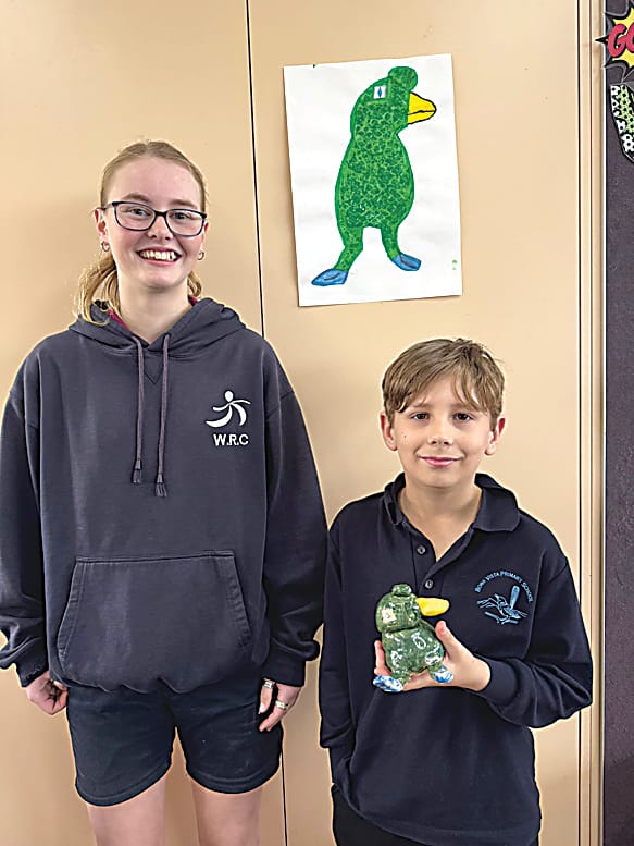 Warragul Regional College year nine ceramics student Libby with her monster creator, Bona Vista grade three student Nathan.
