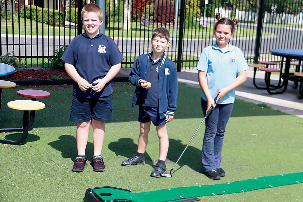 Mason Collins, Riley Blines and Ciara Redpath get the mini golf stand ready for the big day.