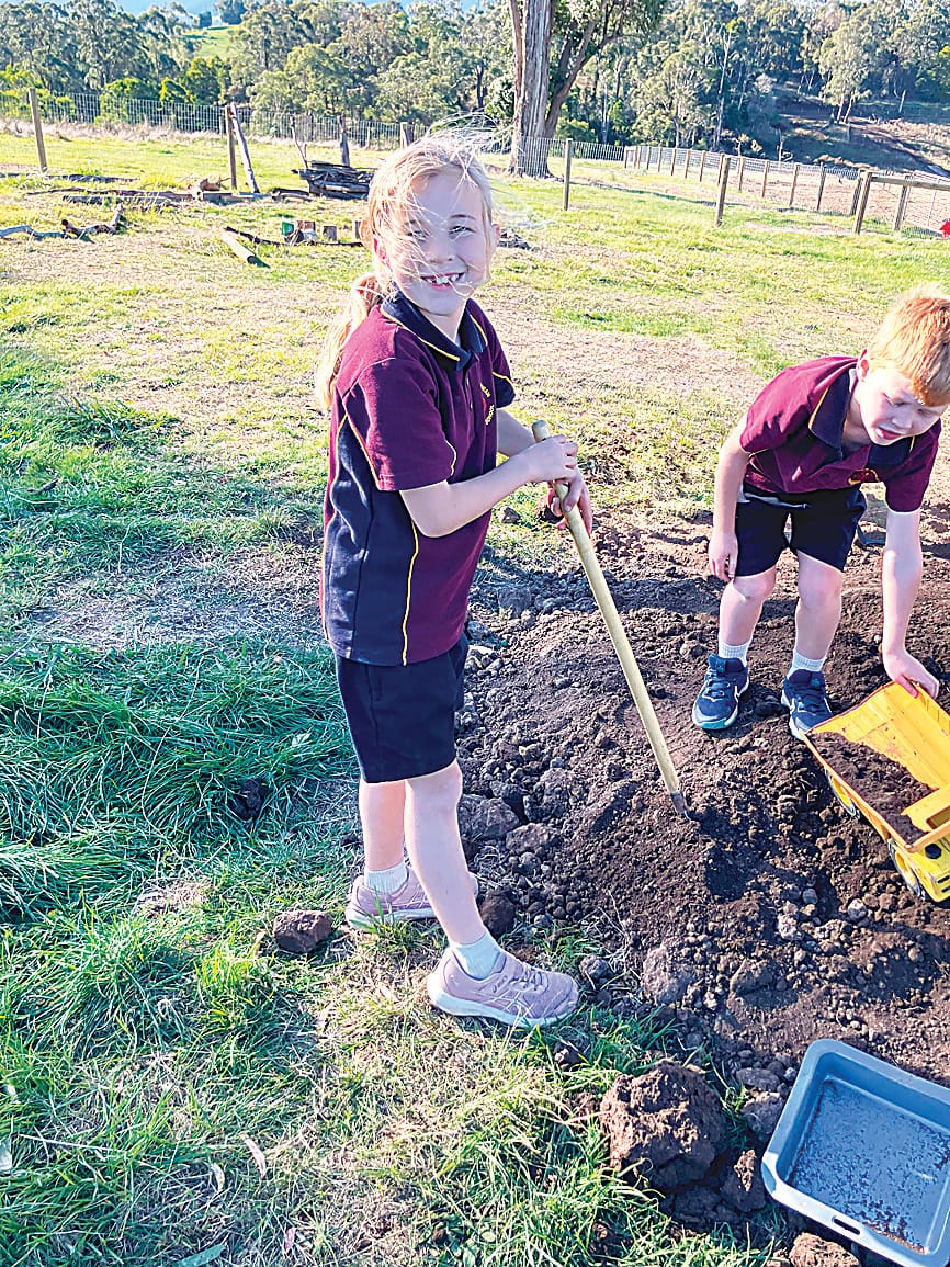 Billie Proctor develops her garden skills by learning how to use a shovel.