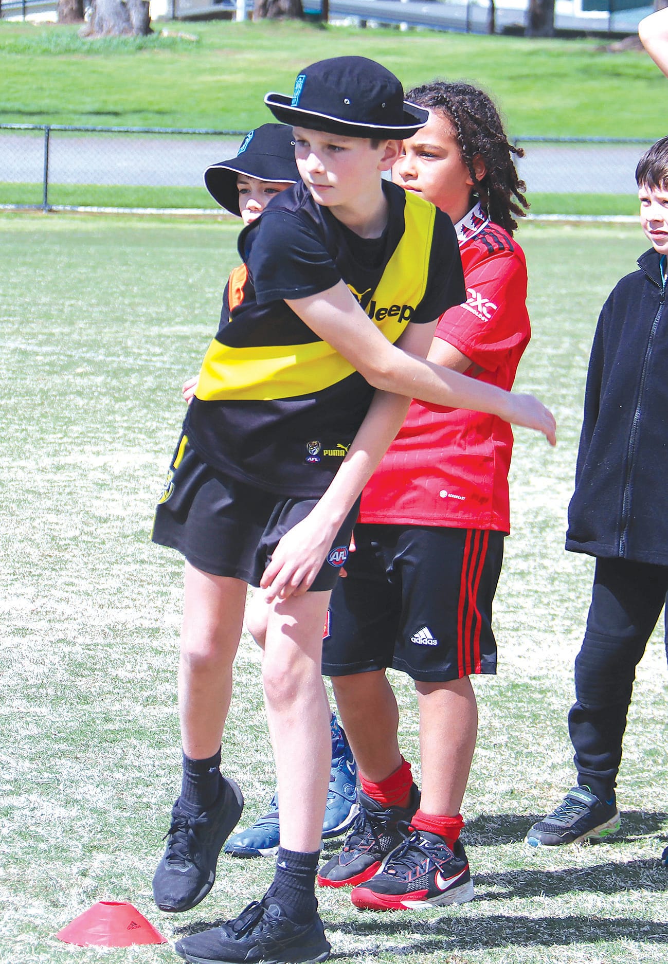 Harvey Wirken throws at the stumps in a cricket drill.