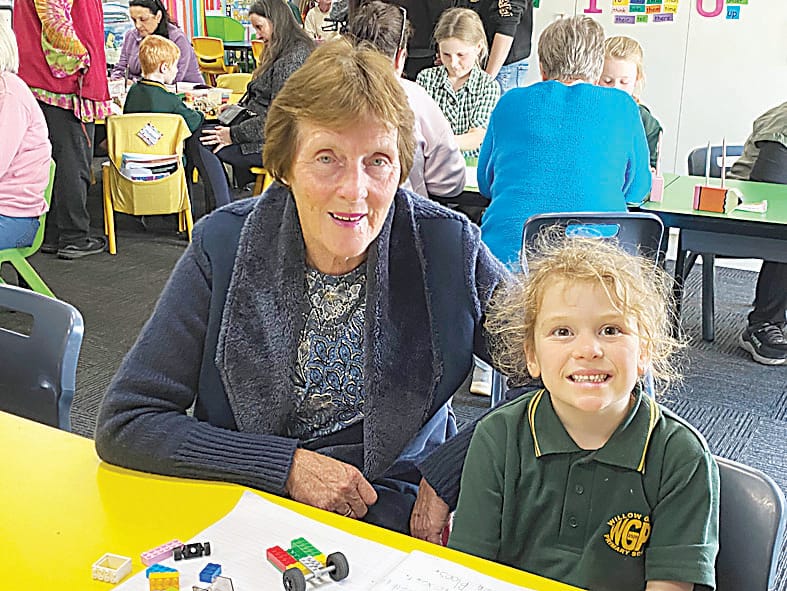 Nellie and her grandmother Glenda building her Lego car.