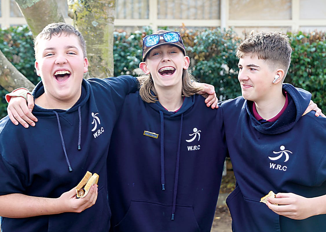 Enjoying the barbecue lunch on offer are (from left) Liam Cameron, Tyler McIntosh and John Tzitziras.  Photographs by AMANDA EMARY