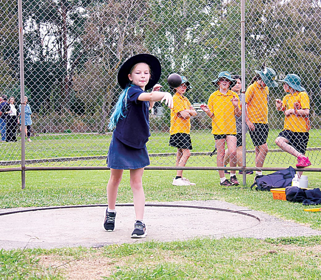Maddi from Longwarry Primary School puts all her power into her shot put attempt.