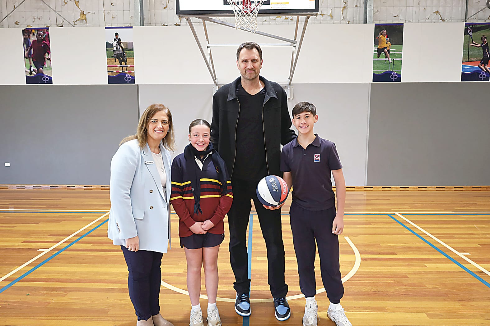 Left: Head of St Paul's Warragul junior school, Melissa McCrae, and junior school captains Mavis Parke and Timothy Townsend with former basketballer Chris Anstey. Anstey, who spoke at the school, played for the Australian Boomers as well as enjoying stints in both the NBA and NBL. 