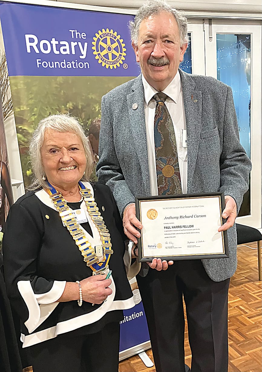 President Lyn Bennett presents a Paul Harris Fellow to outgoing president Tony Carson in recognition of his dedicated service to Rotary and the community.