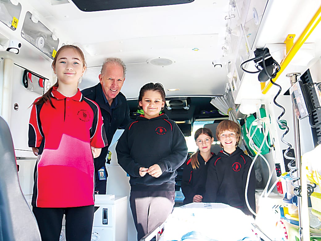 Eager to learn about the equipment inside an ambulance from paramedic Matt Beamish (second from left) are Hazel, Jasper, Darcee and Bobby.