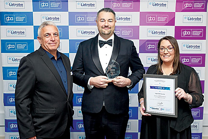 Geoff Wells from Wellington Shire Council (left) presenting Luke Walker (centre) and Kate Page from GippsSAFE Security of Drouin with the business and professional services award.