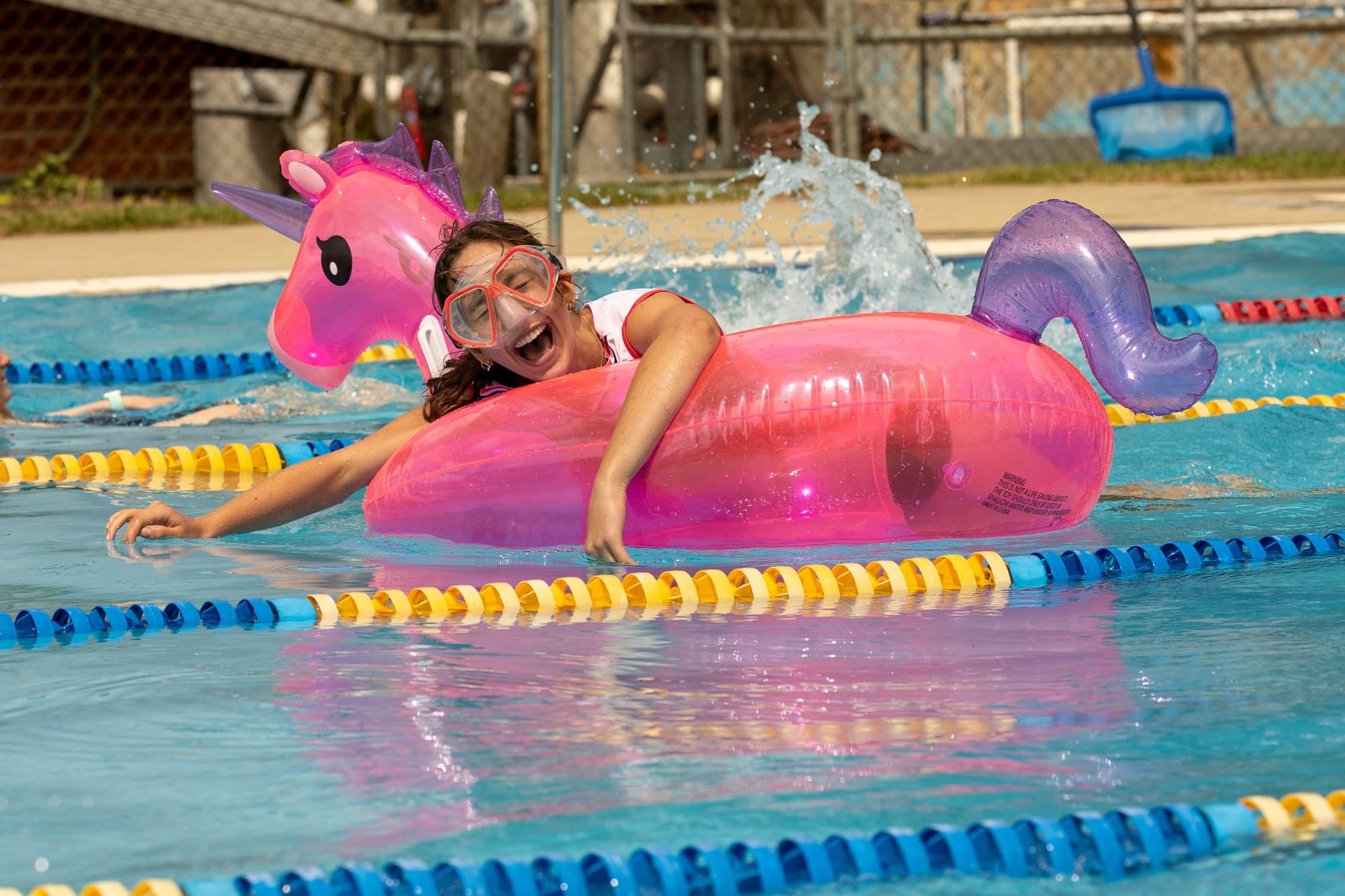 Phoebe Gatti (year 12) with a pink unicorn that joined the Elliot house freestyle relay team at Chairo's senior school swimming carnival.