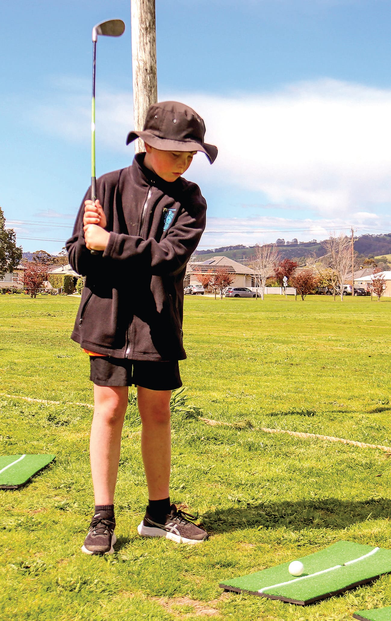 Angus Saxton prepares to tee off in golf.
