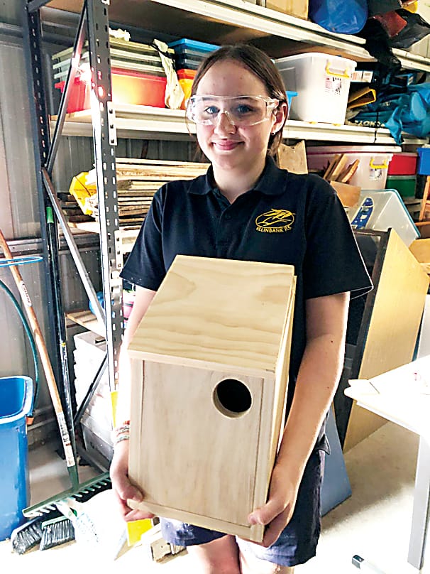 Jasmine Olsson proudly displays her bird house.