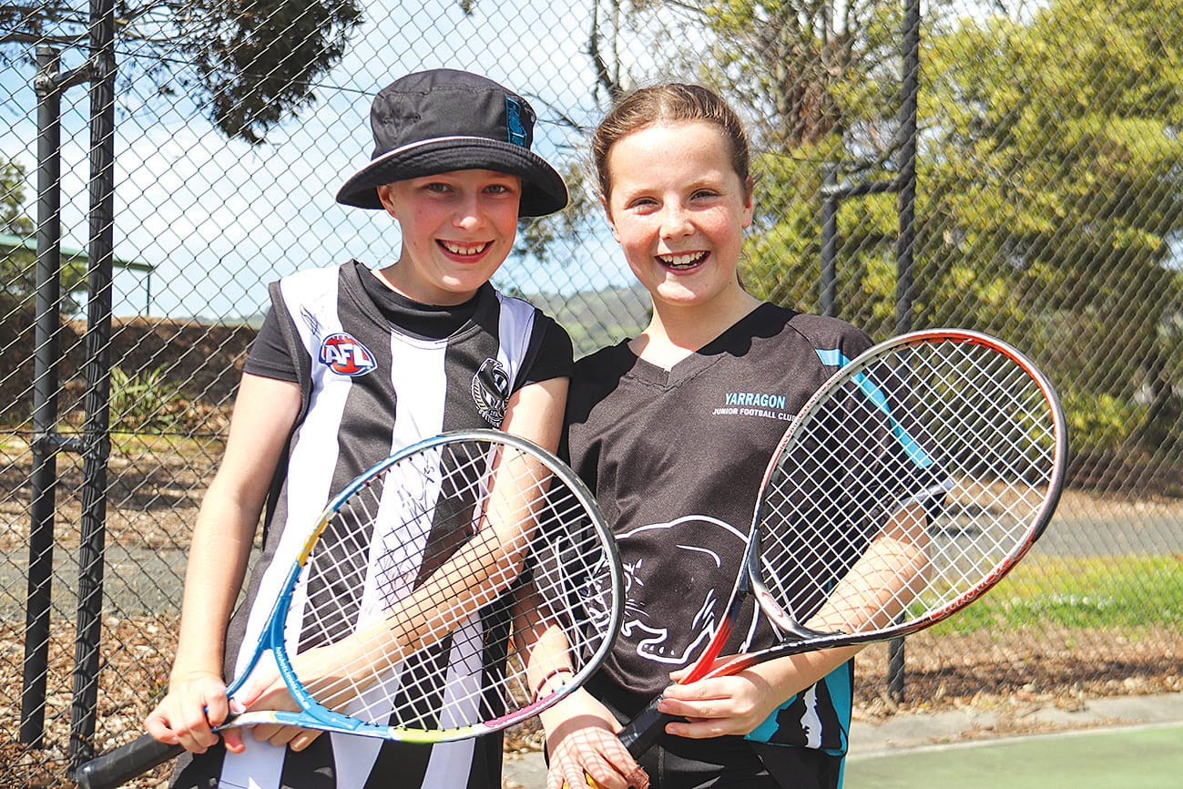 Billie Wedrowicz and Gemma Hosking are all smiles as they learn some tennis skills.