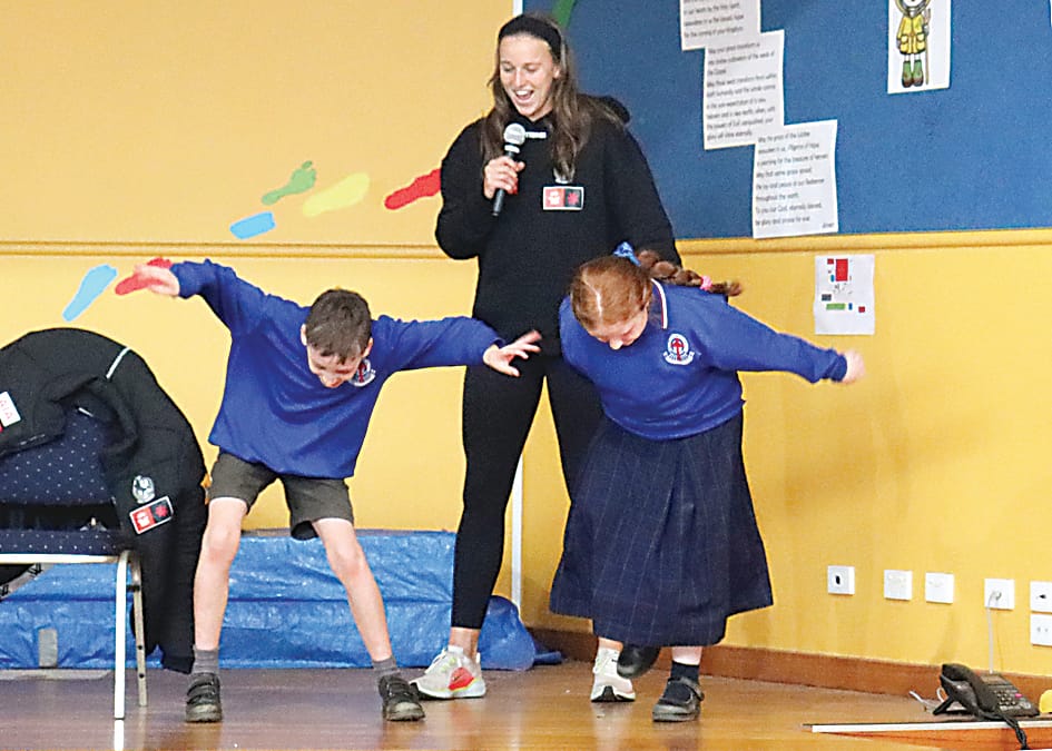 Ruby Schleicher has St Ita's students Ollie Buttigieg and Scarlett Byrne compete in a Fortnite dance contest at St Ita's Primary School on Friday.