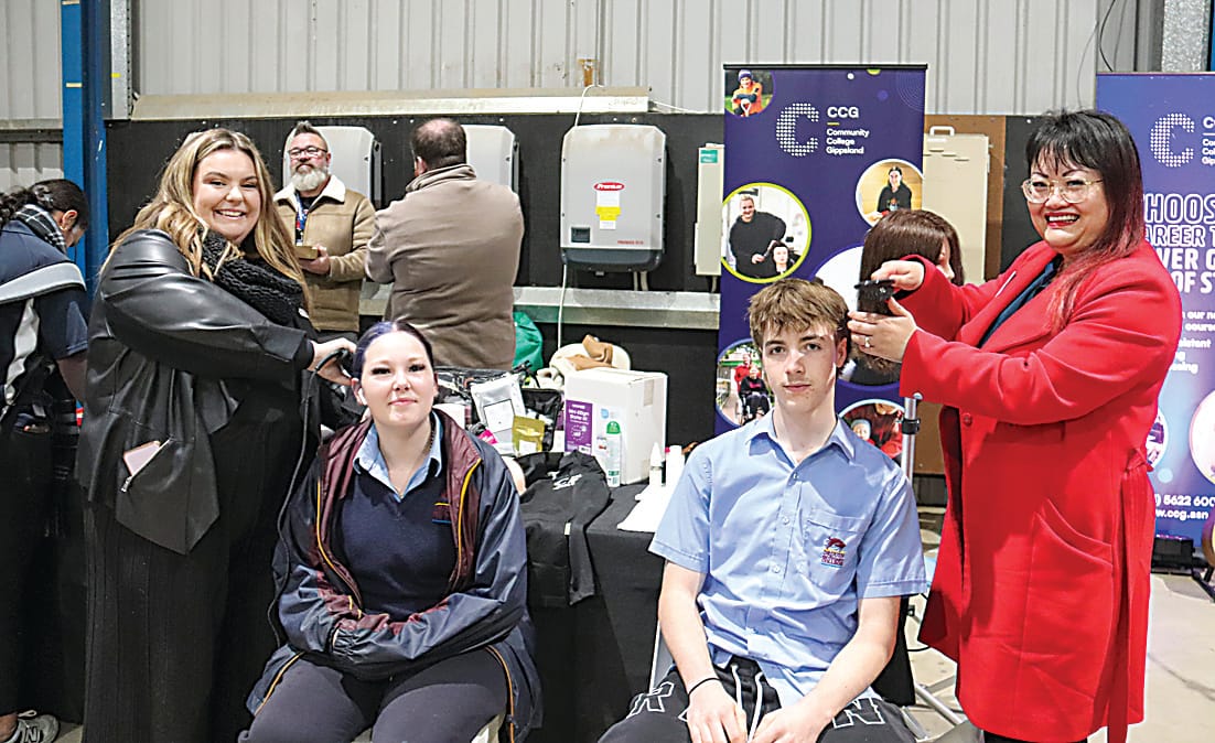 Hayley Naylor (far right) and Den Lim (far left) show off their hairdressing skills for Drouin Secondary School students Sheyanne Pratt and Adrian Hayes