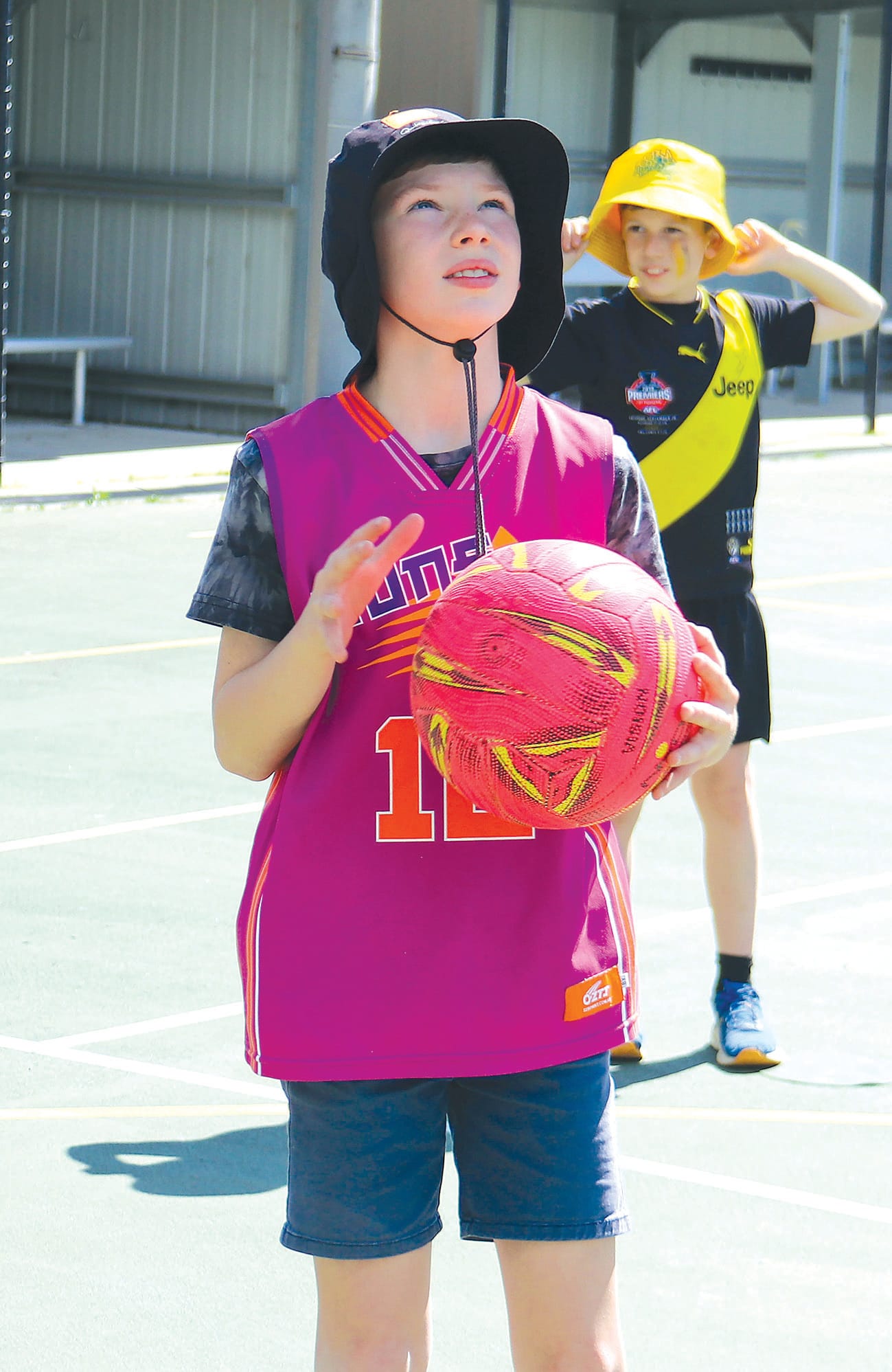 Cooper Lee lines up a shot in netball.