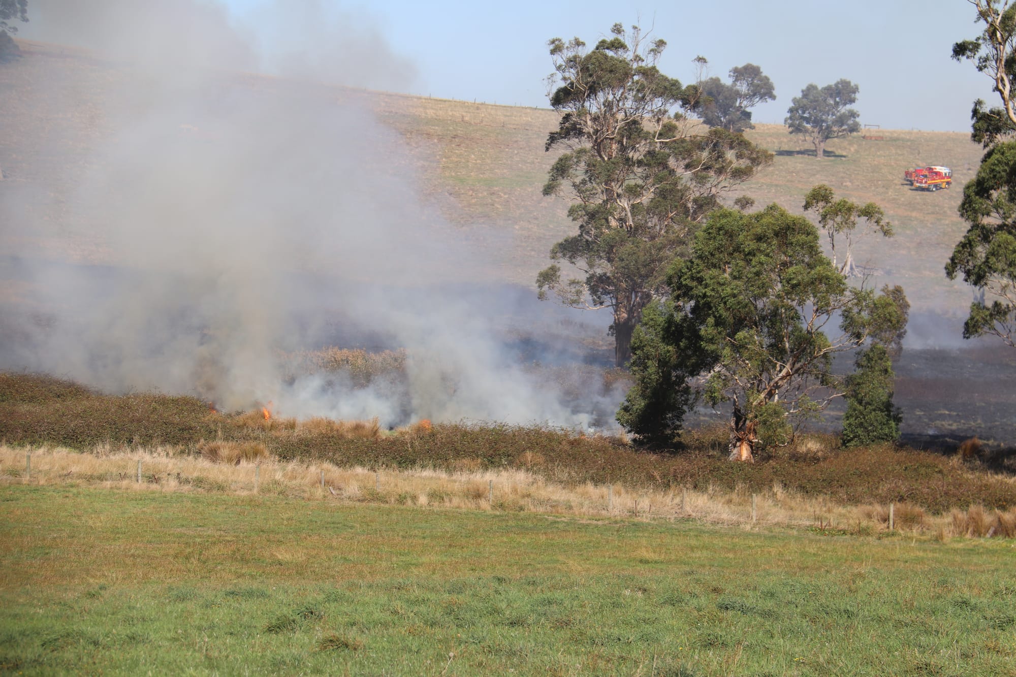 CFA volunteers work to extinguish a 20 acre grassfire in Drouin on Thursday afternoon. The fire was ignited after a suspicious fire at an abandoned farmhouse on Weebar Rd.