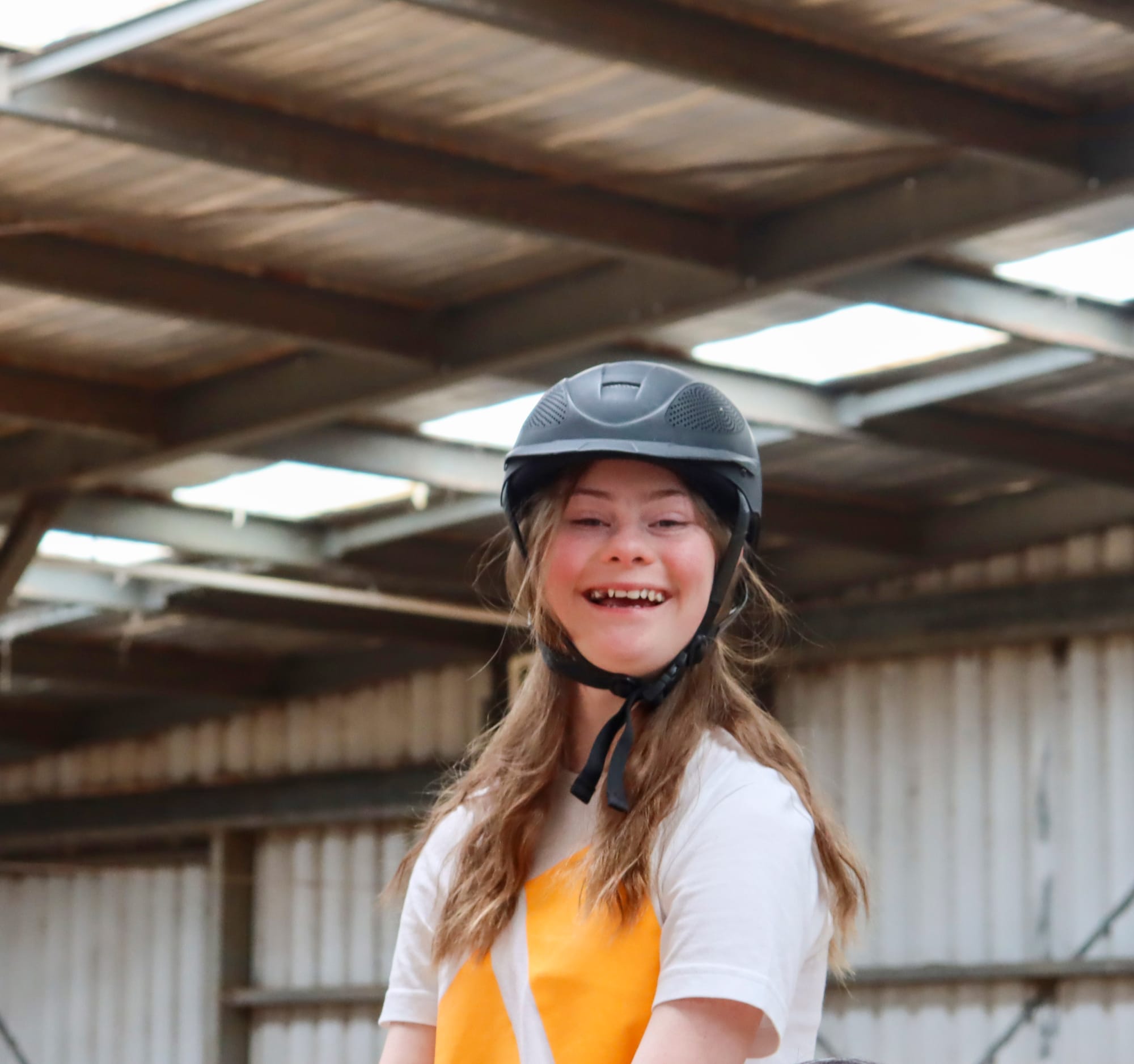 Volunteers helping riders interact with horses