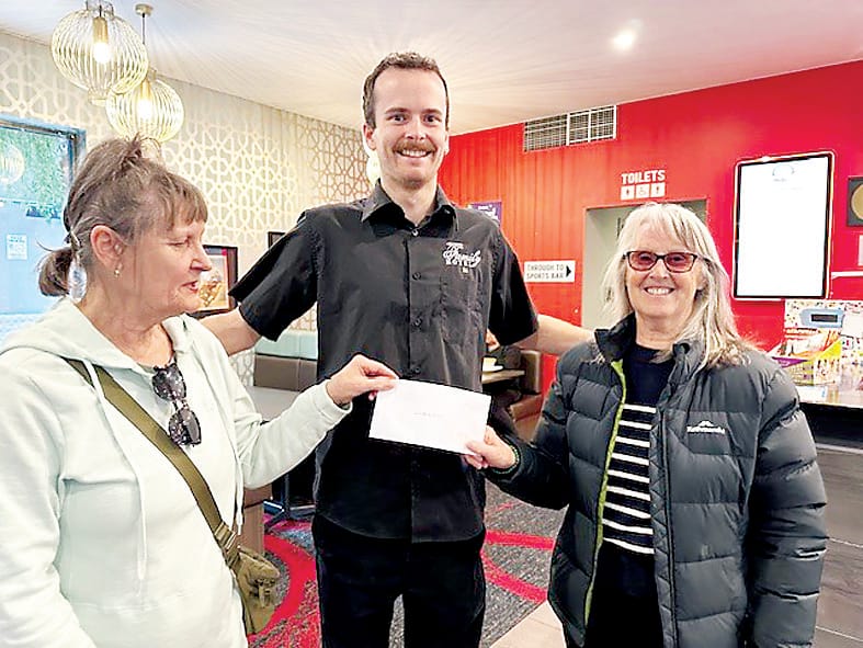 Drouin Community Garden volunteers Yola and Deb gratefully receive a donation from Family Hotel representative Jai.