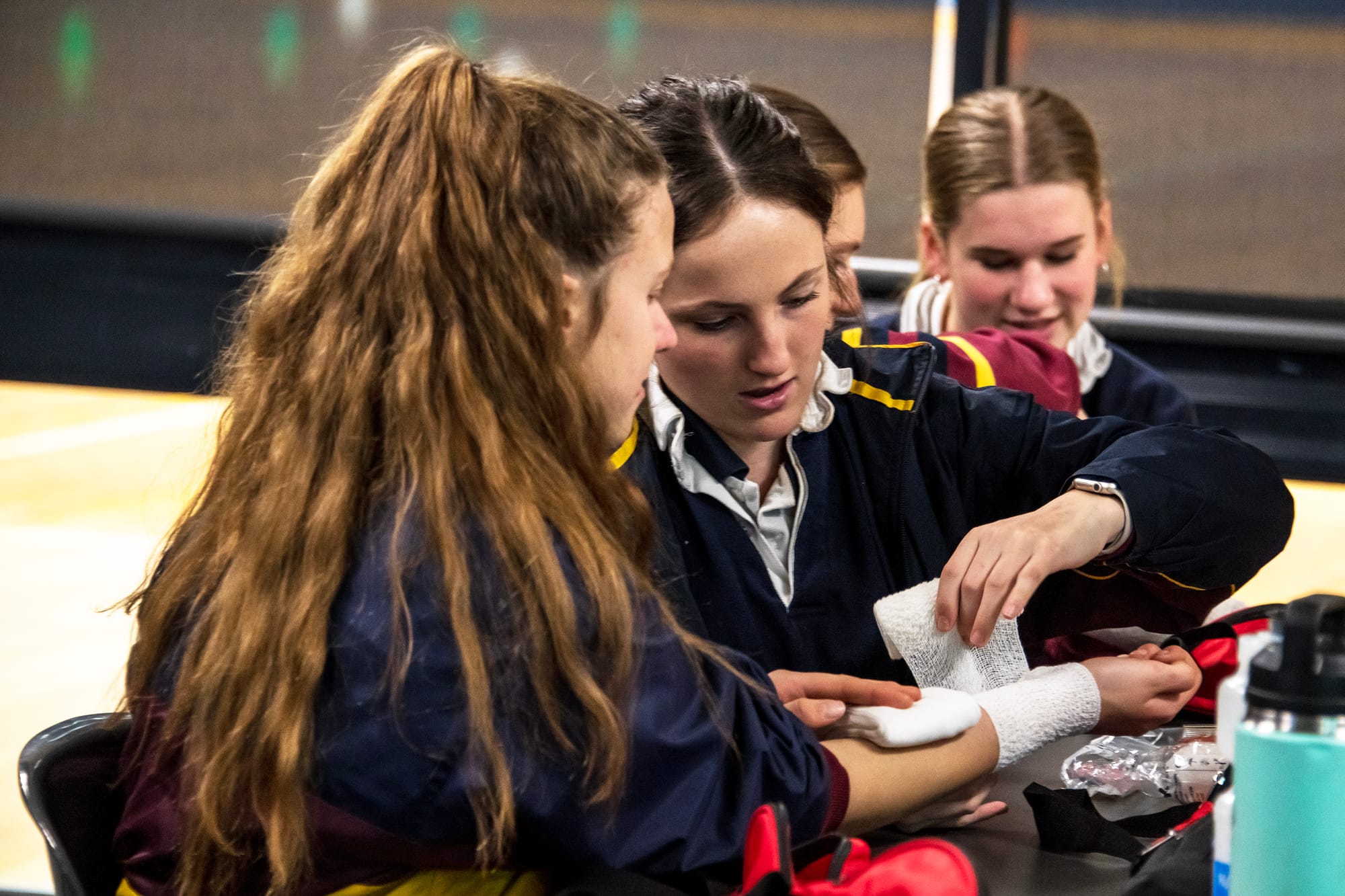 First-hand training leads to first-hand learning as Livi Shone bandages Indily Francis.