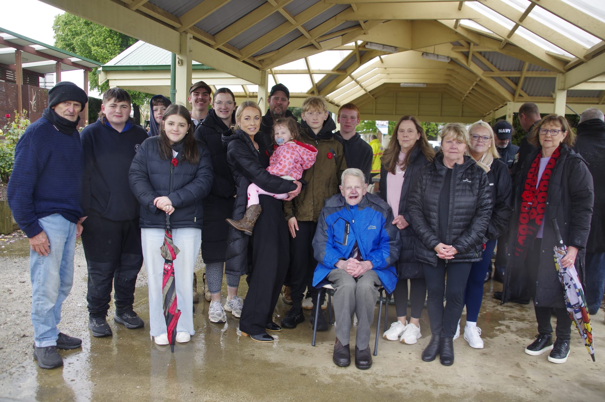 Raising the flag for the final time at last Tuesday's Remembrance Day service is 92-year-old Stan Gleeson, srround by family including Riley Willis, George McLaughlan, Bonnie Barker and Leah Gibson.