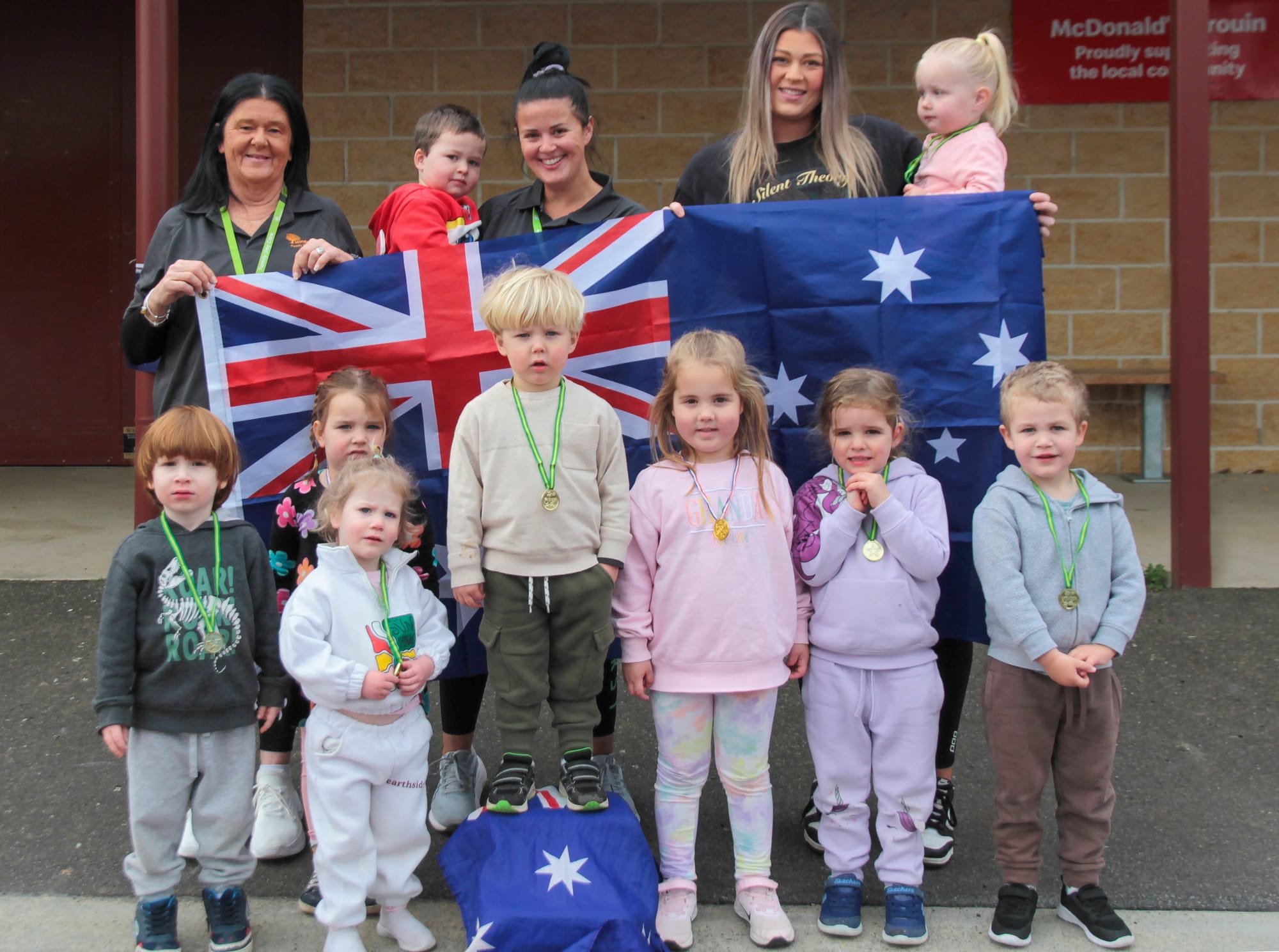 Celebrating the 2024 Paris Olympics are (back) Maureen Kelly (educator) , Harley Richards, Sophie Gray (educator), Lauri Skewes (educator), Sage Baker, (front) Pace Powell, Billie Pearson, Logan Walsh, Henry Wagner, Frankie Morrow, Anna Bruce and Darcy Clark.