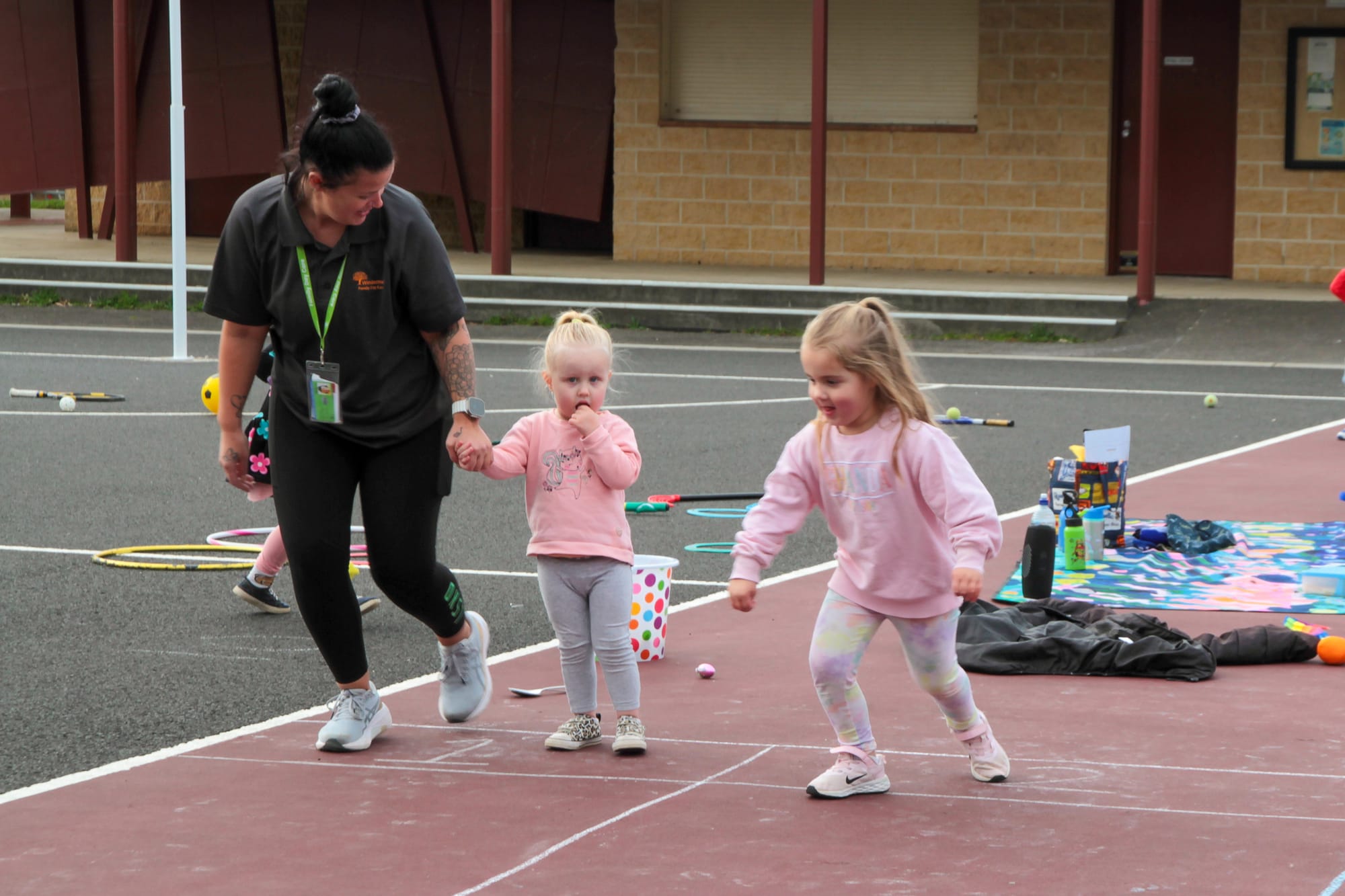 Educator Sophie Gray leads Sage Baker and Frankie Morrow through some of the Olympic events. Photographs: AMANDA EMARY