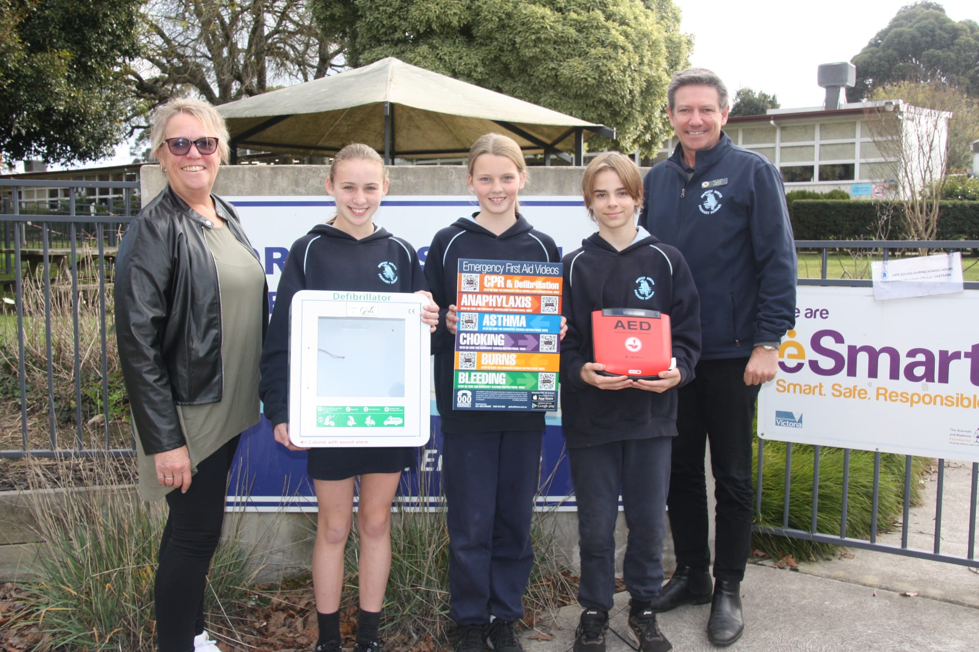 A Girls' Day Out committee member Margie Whitford at Drouin South Primary School Ashlyn, Caitlin, Archie and principal Michael Smith.