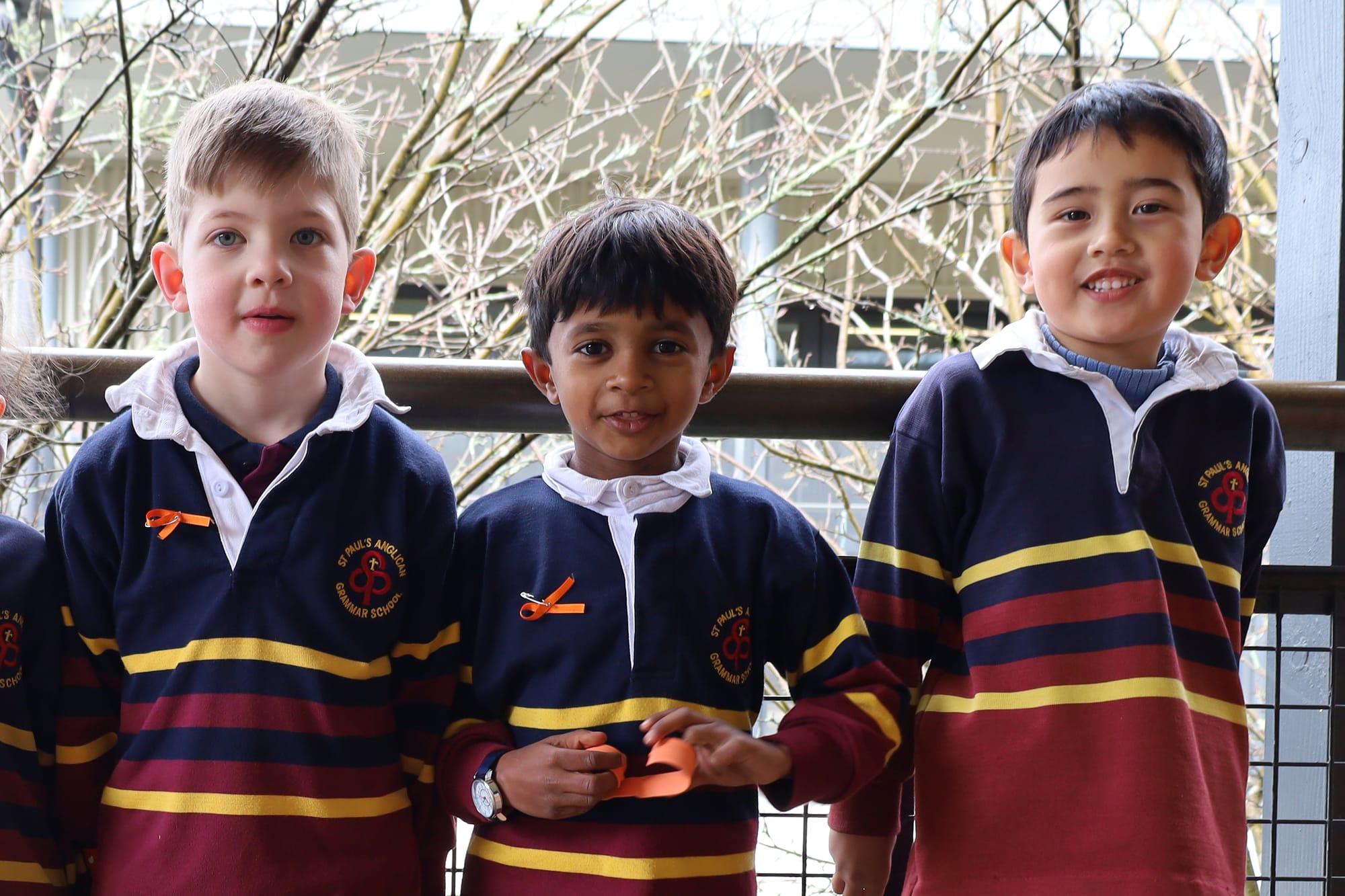 George Martin, Naman Vishwanatham and Hadi Muteir wearing the bows the SRC made for students in support of NDA.