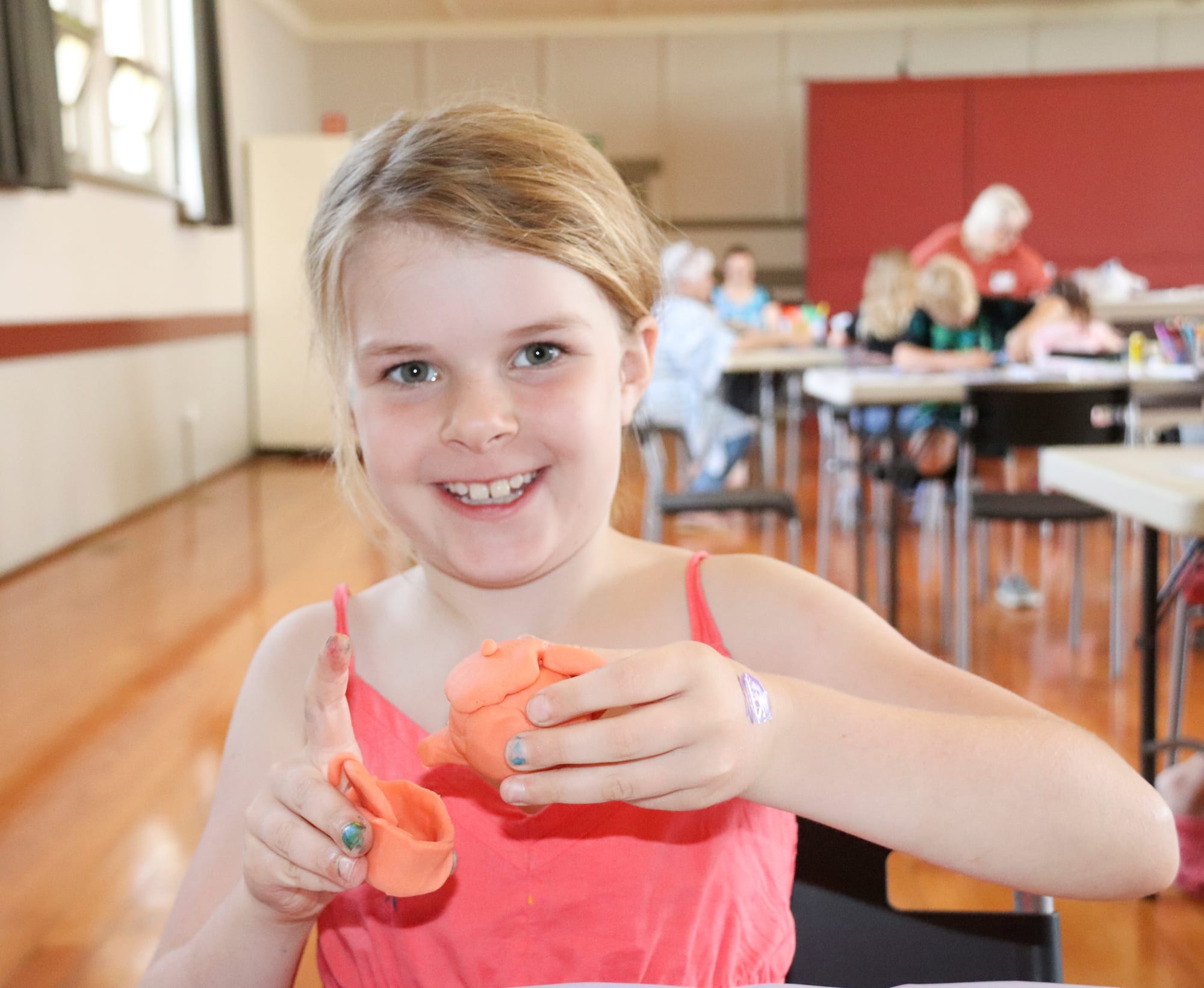 Gracie Gralach pours an imaginary cup of tea into her handmade clay tea set at Trafalgar on Thursday.