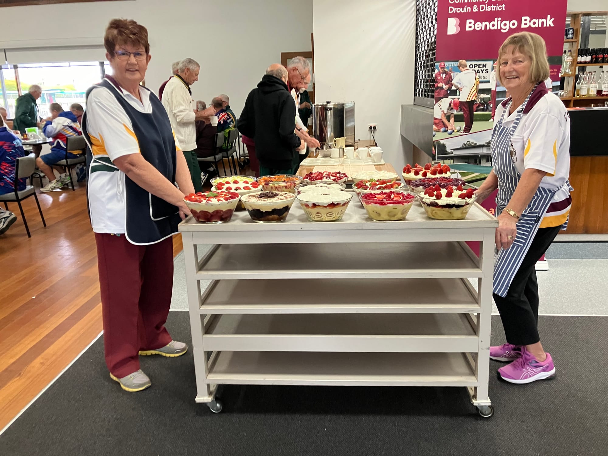 Lyn Jeffrey and Dini Hone stand guard on the trifle trolley as the players come in for lunch.