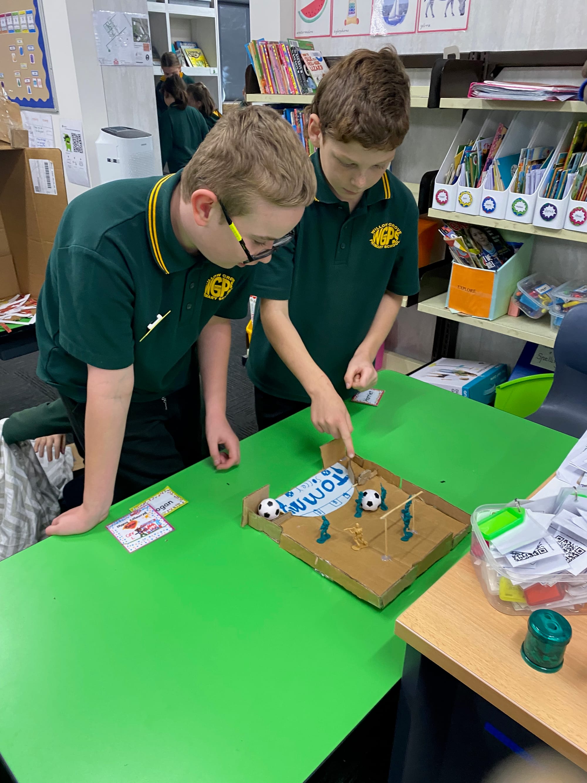 William and Tommy playing an arcade soccer game