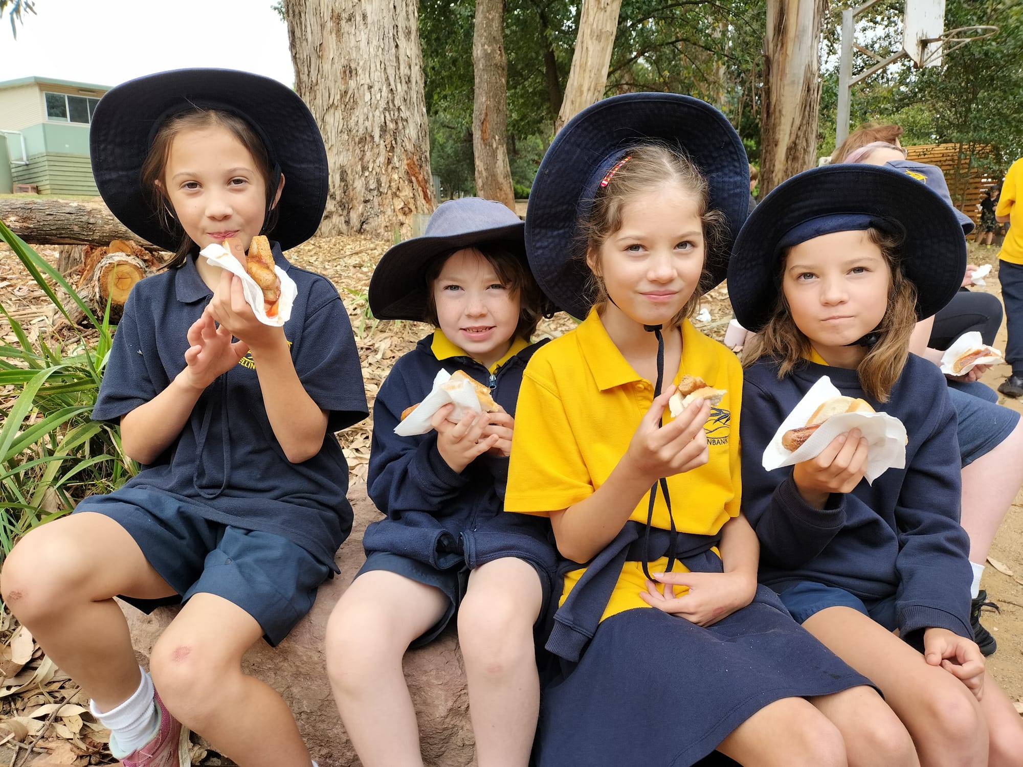 Willow Gonzalez, Jack Foley, Eliza Conroy and Eden Conroy enjoy a well earned sausage after the athletics day.