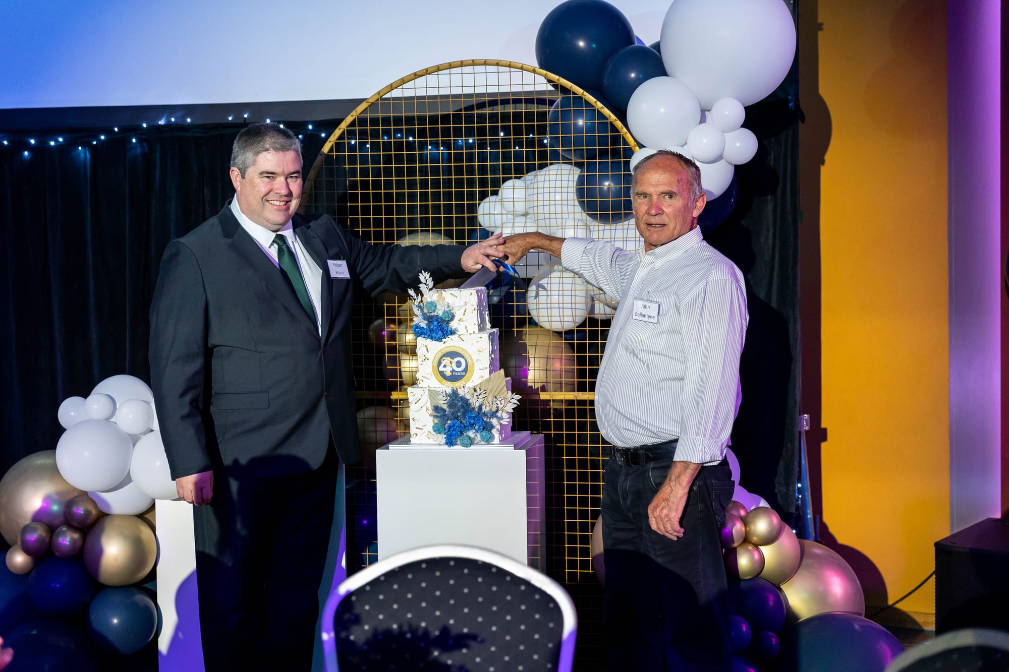 Current board chair Rob Bruce and long-serving past board chair John Ballantyne cut the cake at Chairo's 40-year celebration dinner