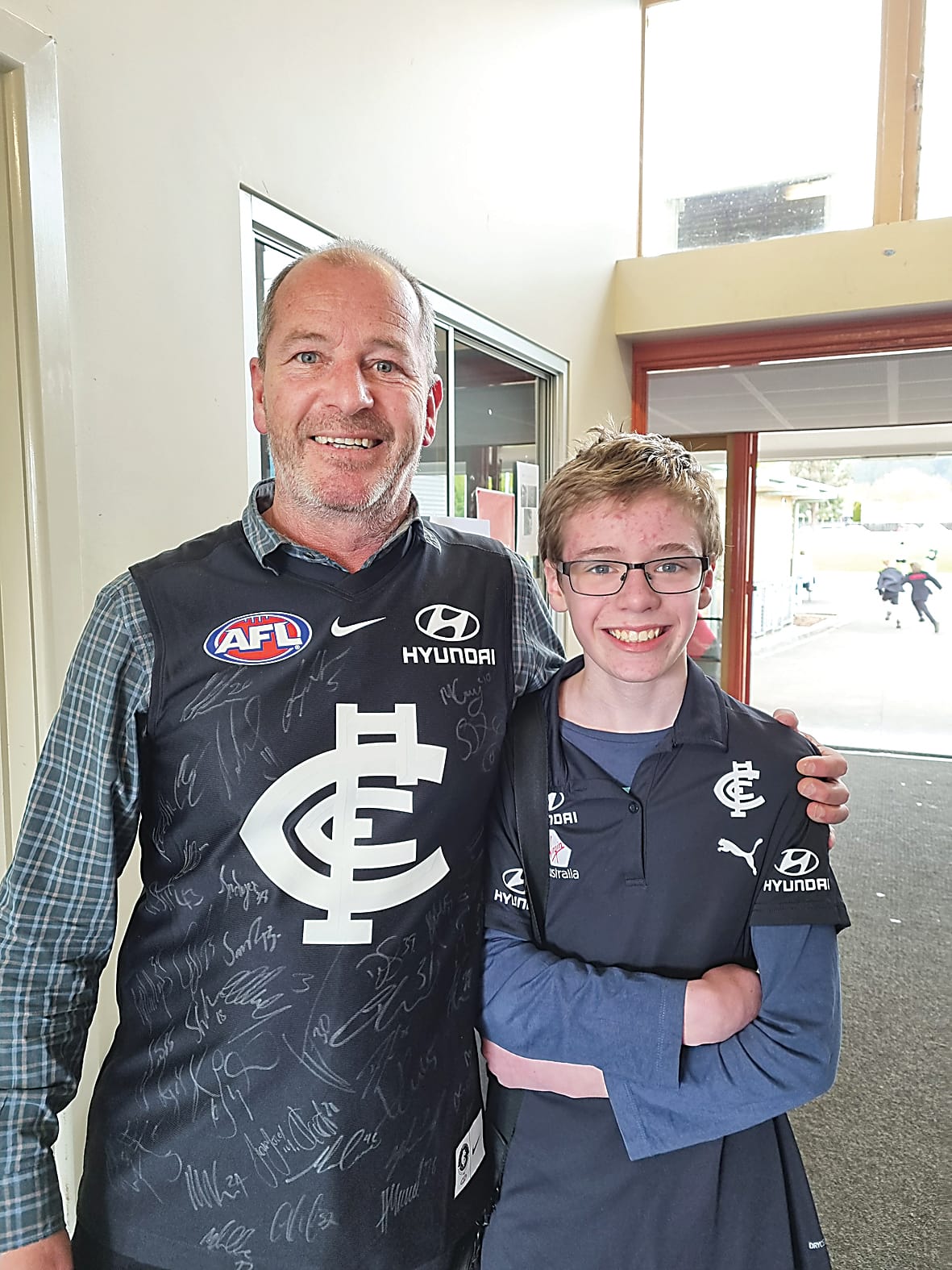 Middle years leader Hayden Draper with fellow Carlton supporter Blake Stone.