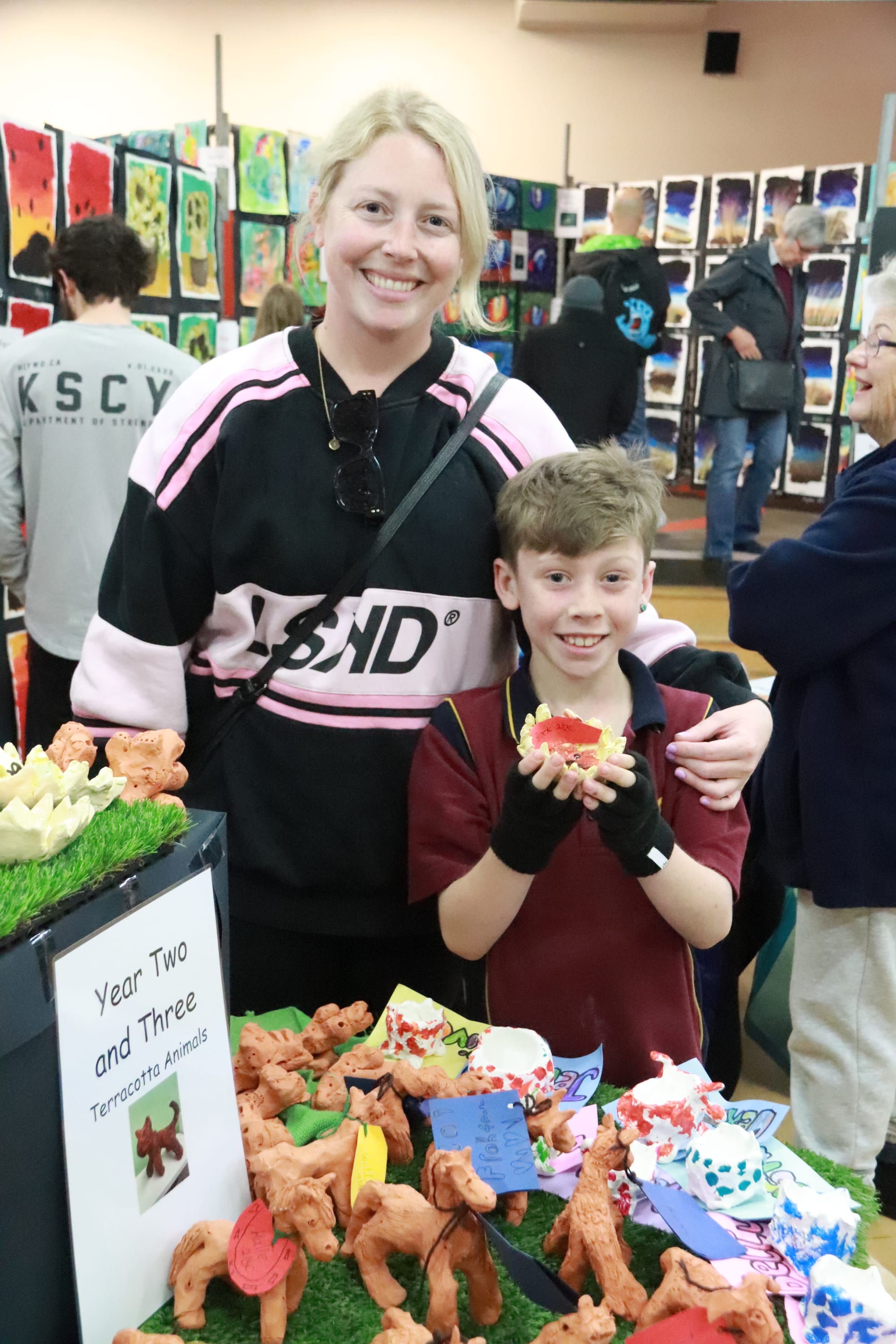 Brock Strattan shows mum Annmaree his ceramic tea light holder at the Drouin Primary School art show.