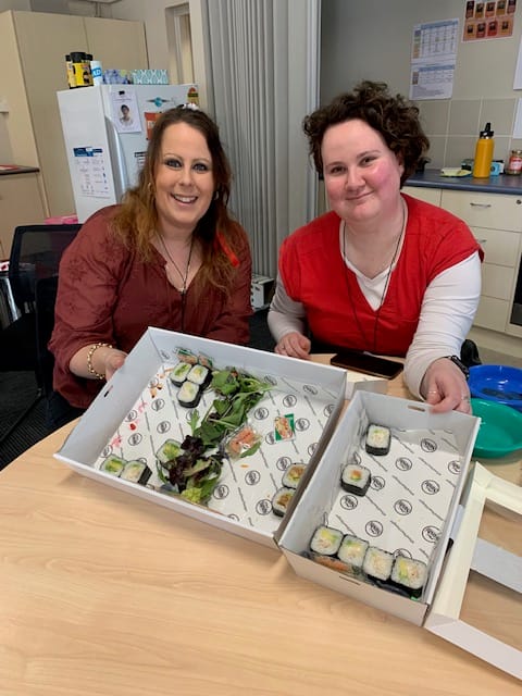 Staff Stacey Lia and Jessica Cross enjoy sushi for lunch.