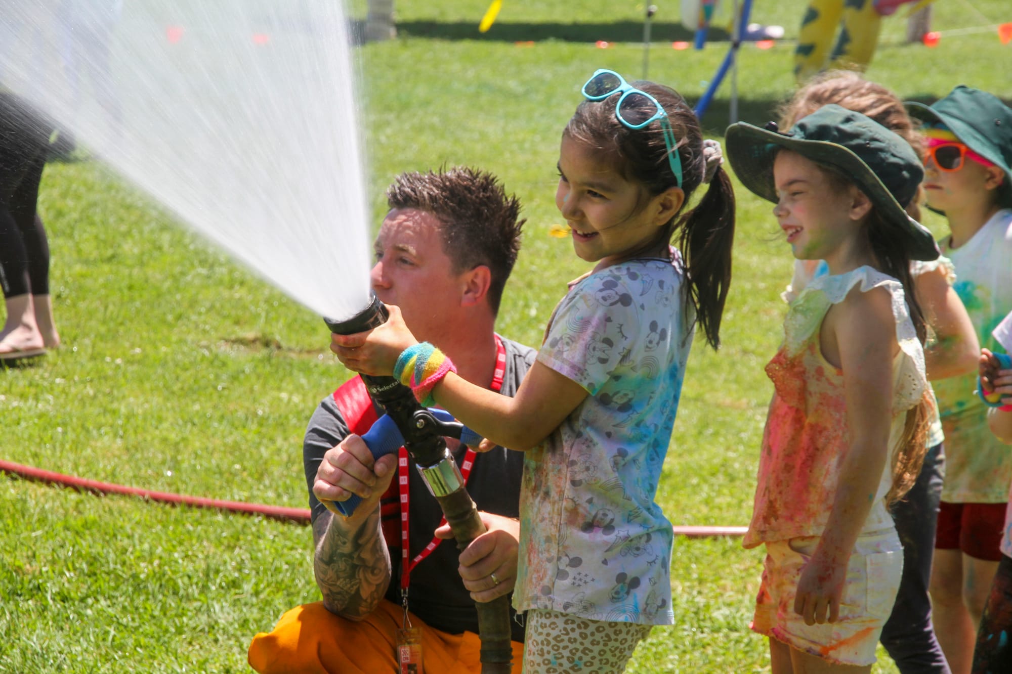 Taleya holds the fire hose at the St Joseph's Primary School Colour Run.