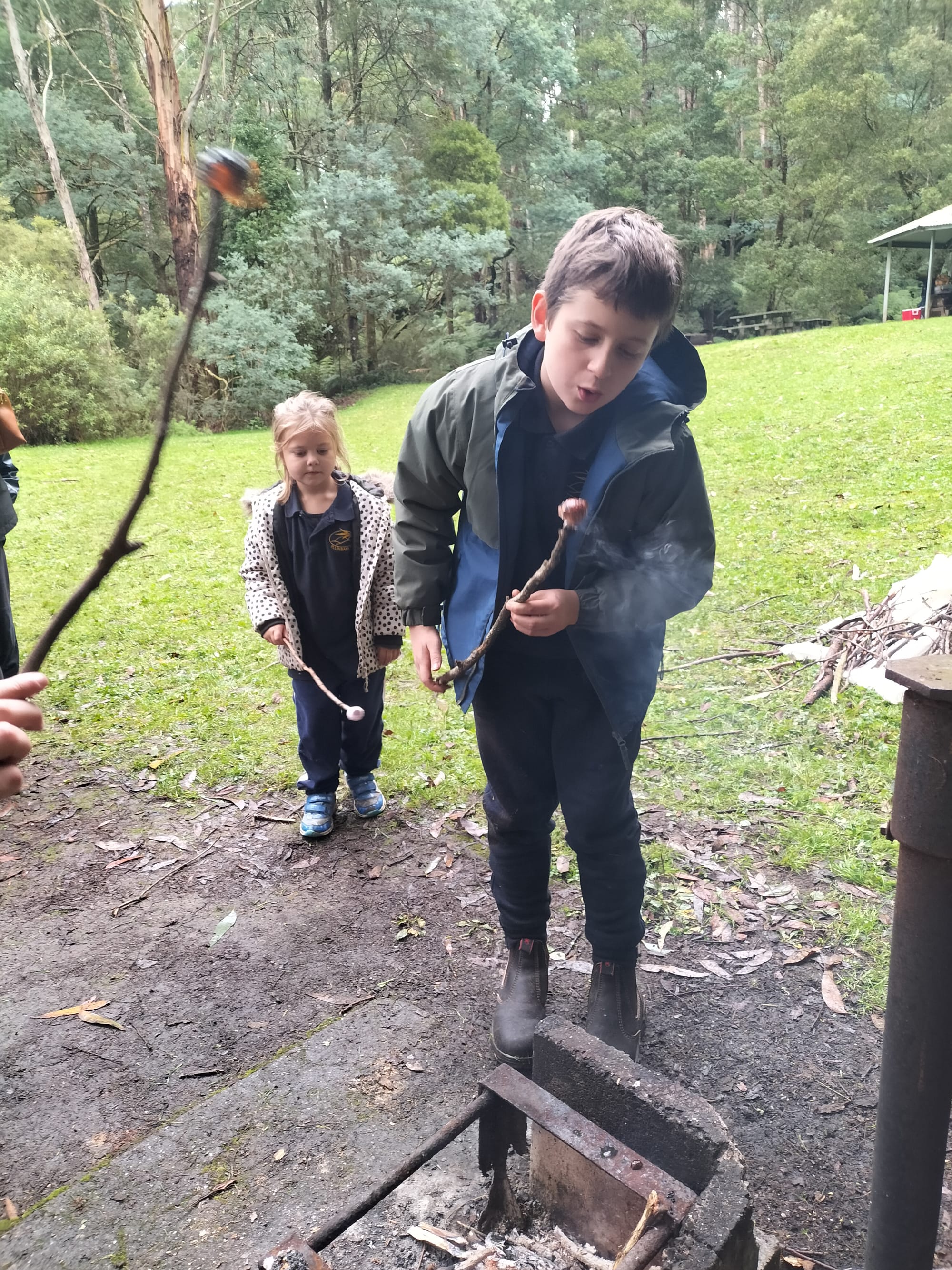 Angus Pollock blows on his marshmallow before digging in.